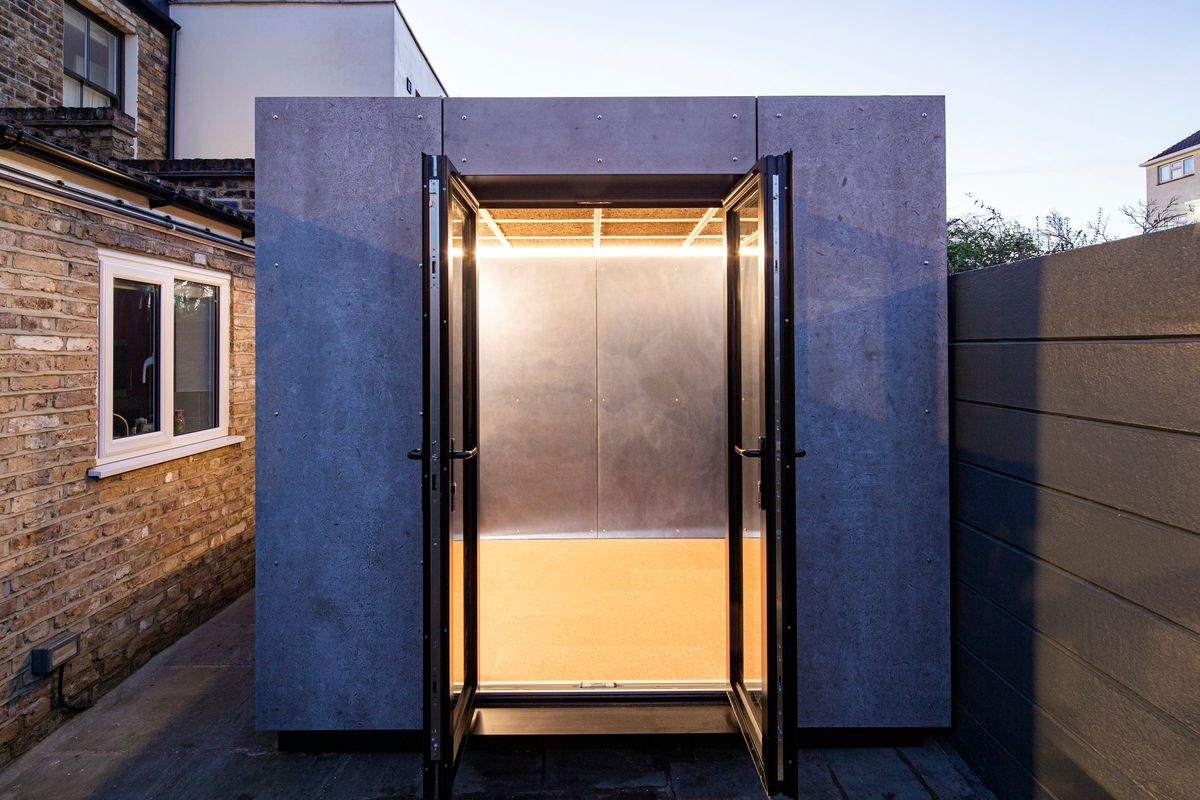 Glazed double doors open, the lit interior glowing