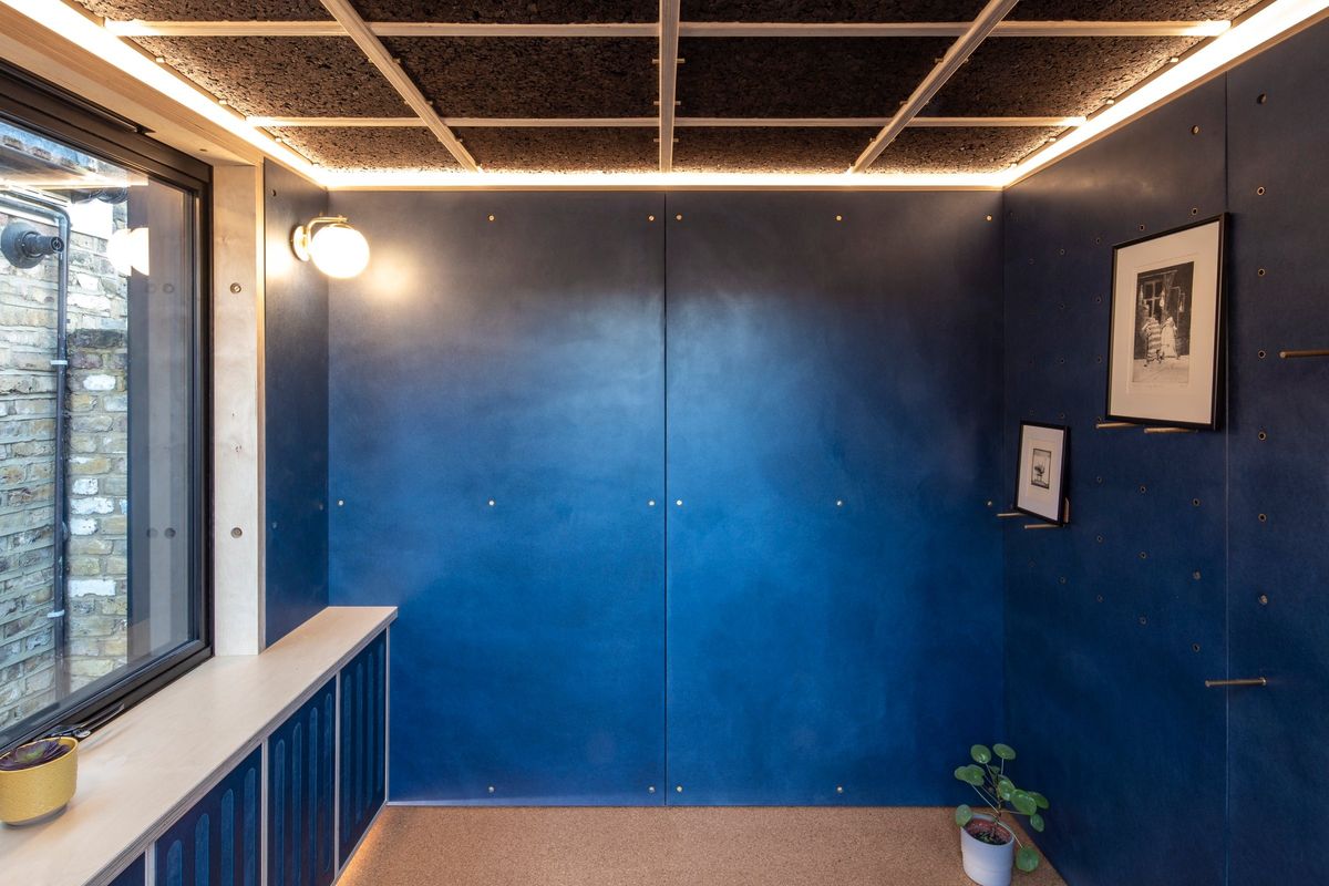 Blue room with cork ceiling grid, window bench and frames