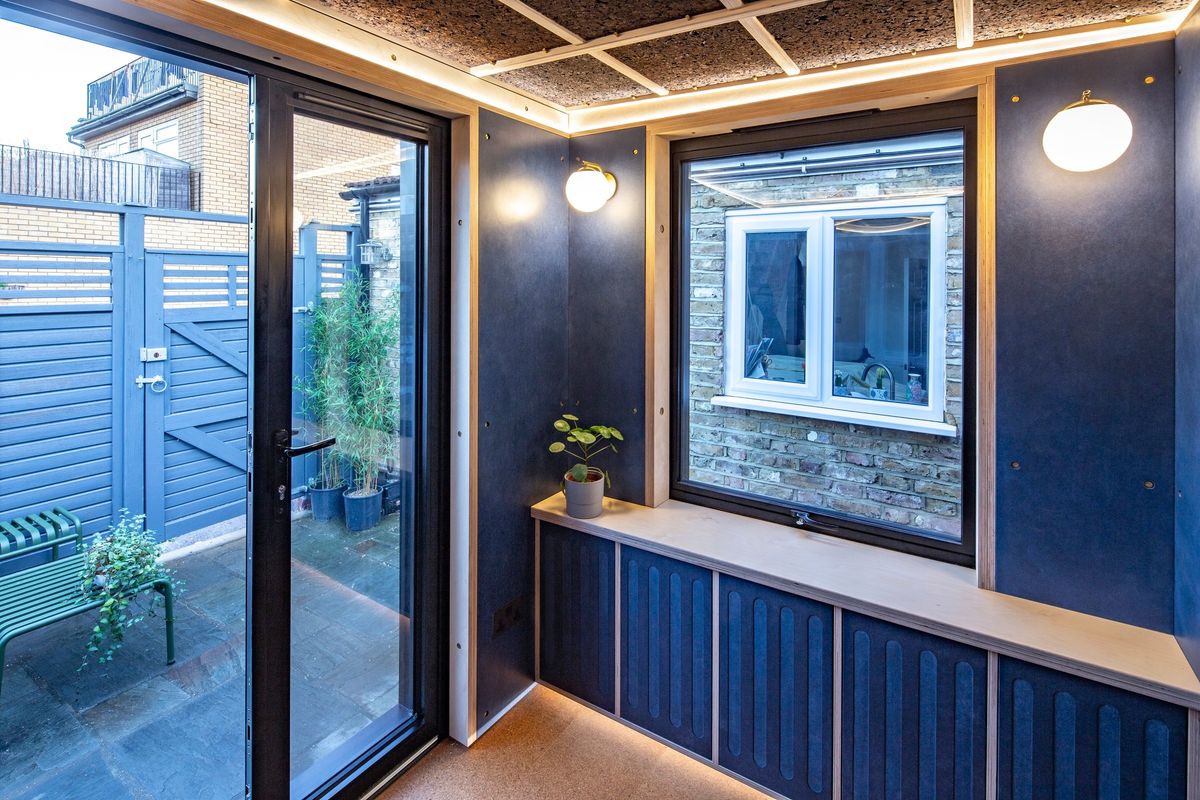 Glazed door to the yard and the window over the storage bench
