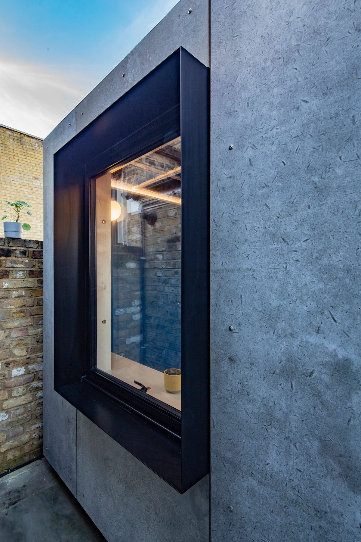 Deep black window reveal in the concrete wall