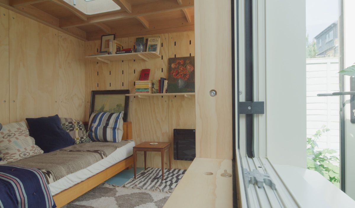 Sofa bed, pine panelling, shelves and the skylight edge