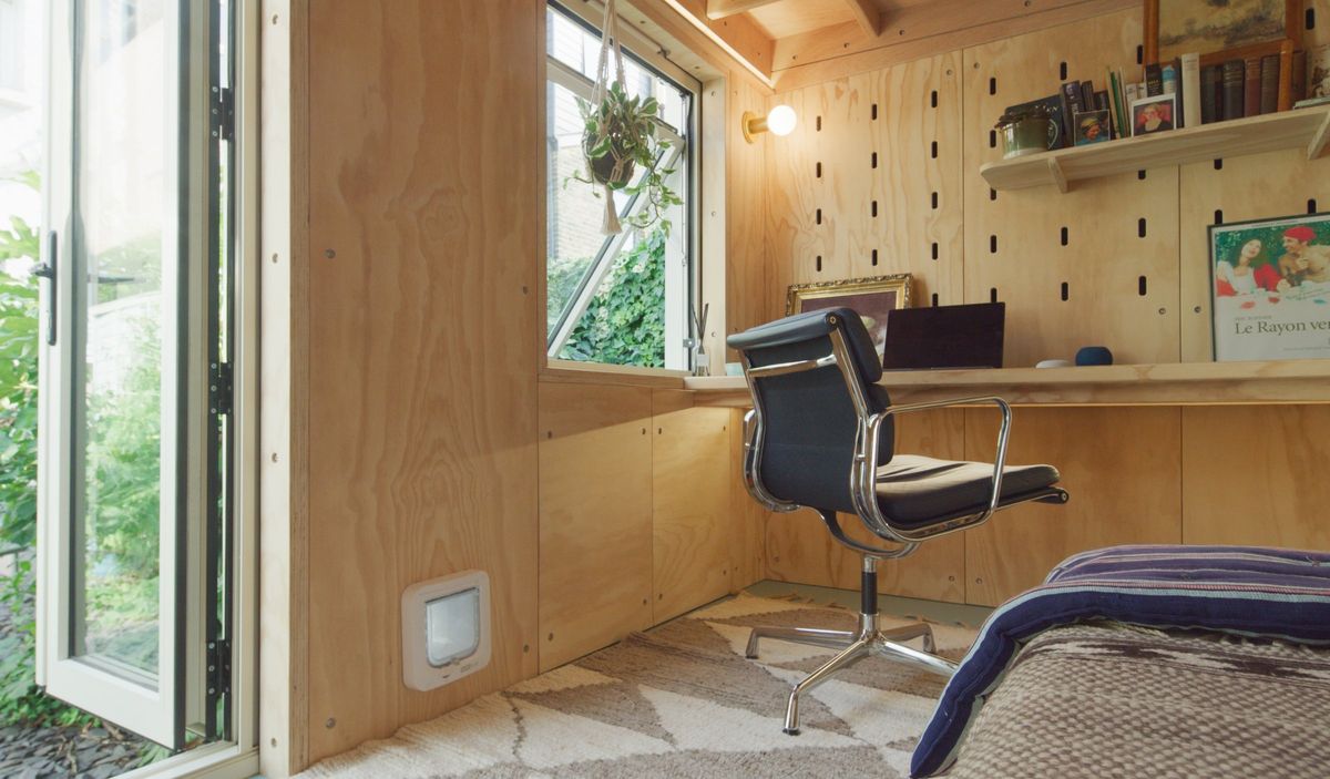Desk under the window, peg wall and the cat flap