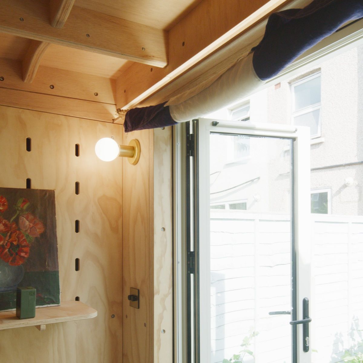 Peg wall, wall light and the open door from inside