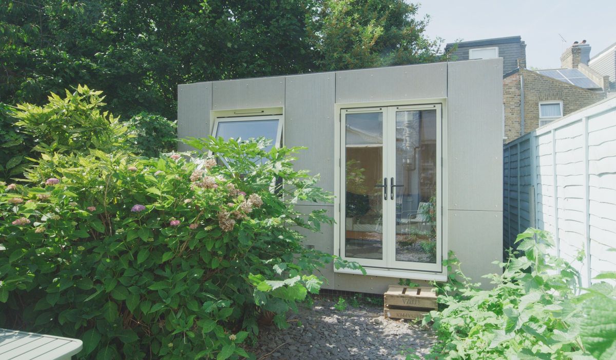 The studio in its garden behind the hydrangea, Viroc cladding and cream doors