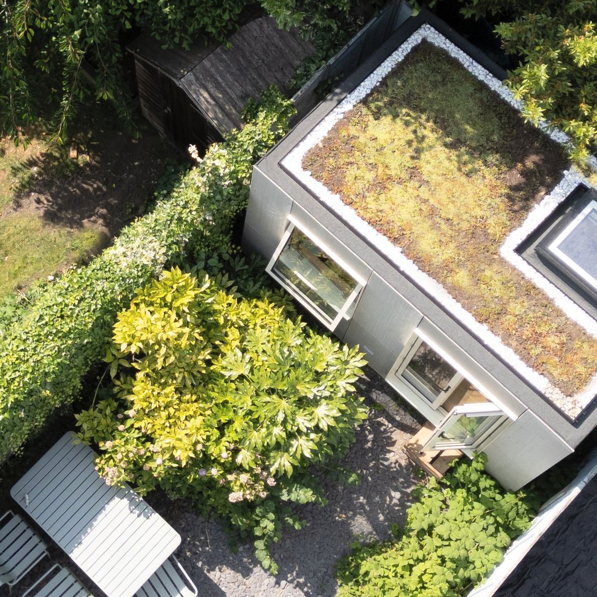 Green roof and skylight from above, garden table beside