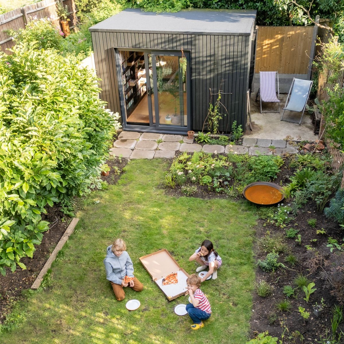 The studio at the end of the garden, children on the lawn