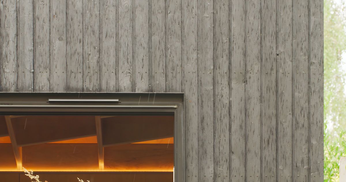Charred cladding over the window, warm light inside