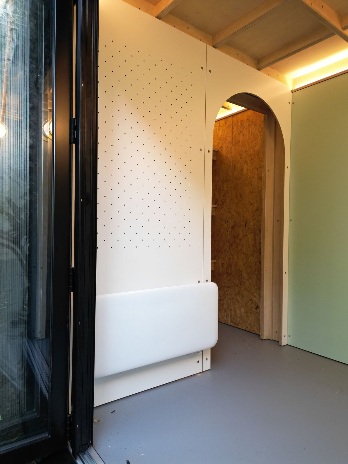 Arched door open onto the storage room, seen from the doorway
