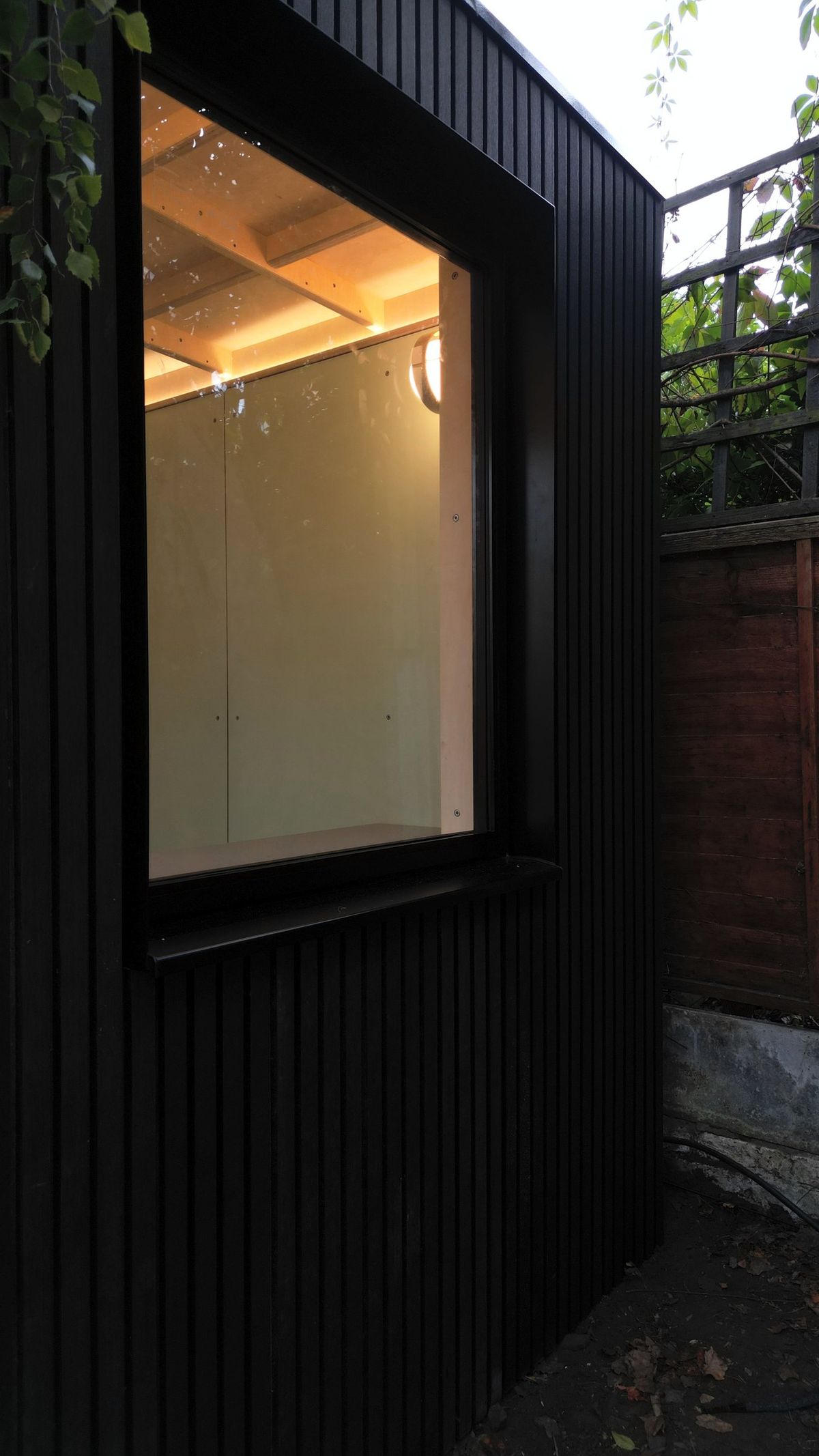 Deep black window reveal and frame on the dark cladding