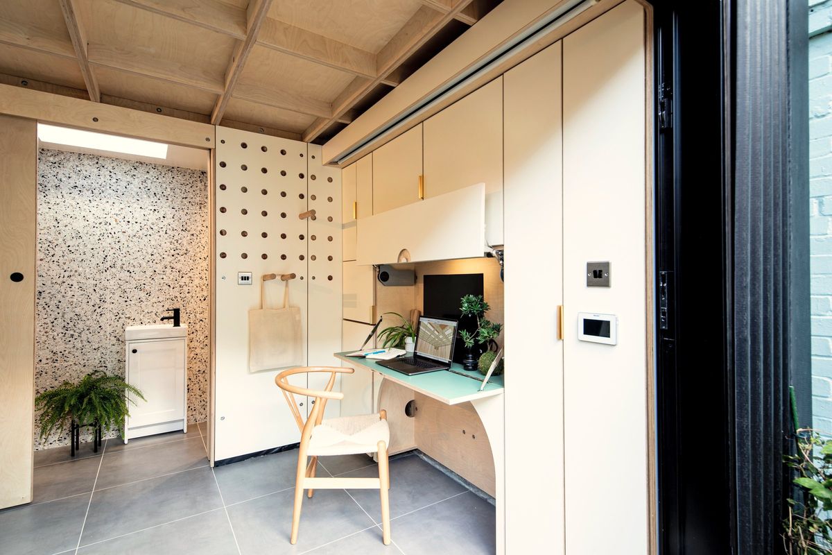 Desk wall, tall storage and the basin through the WC door