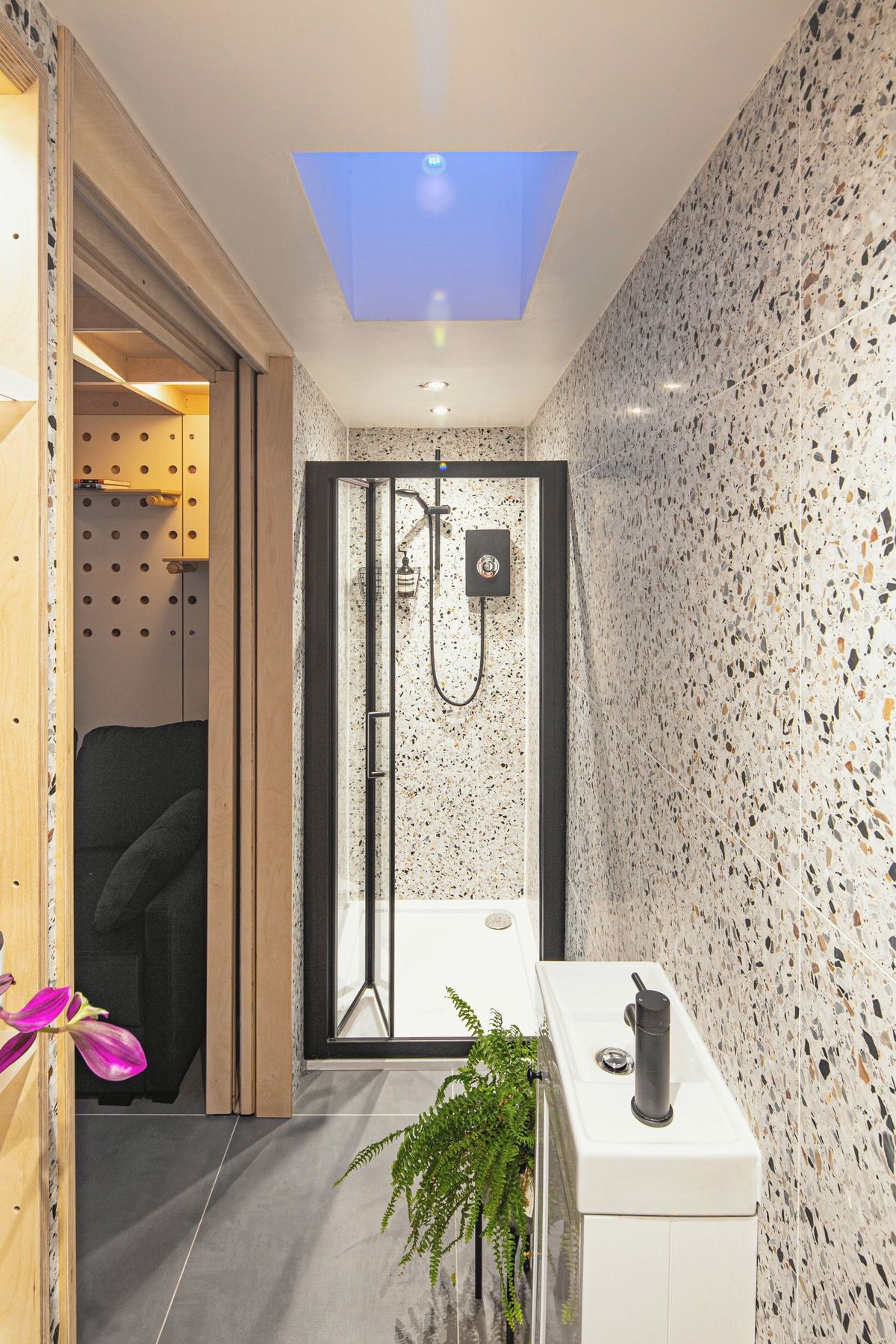 Terrazzo-lined corridor to the en suite shower under a skylight