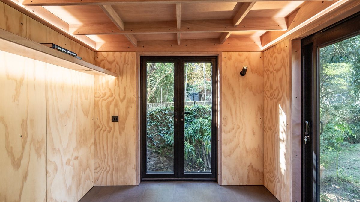 Inside the garden office: ply walls, coffered ceiling, LED shelf and garden doors