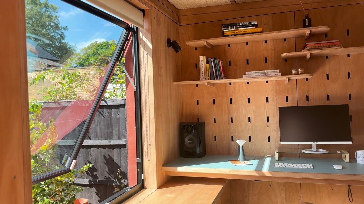 Open window to the garden beside the desk wall