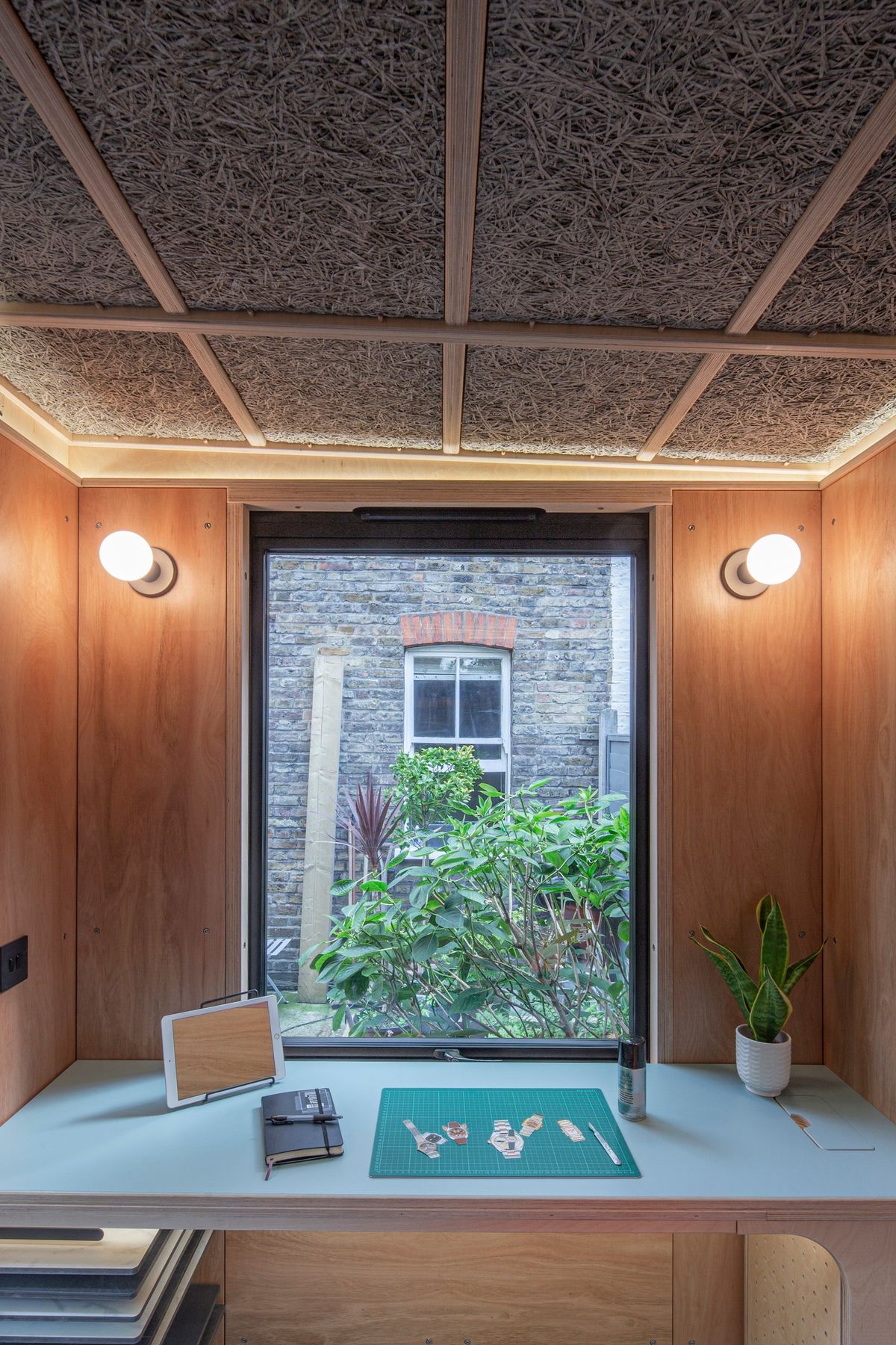Desk facing the big window and the garden planting