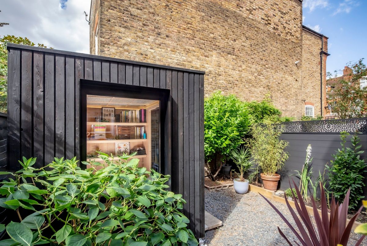 Front view: shelves seen through the large window, planting in front