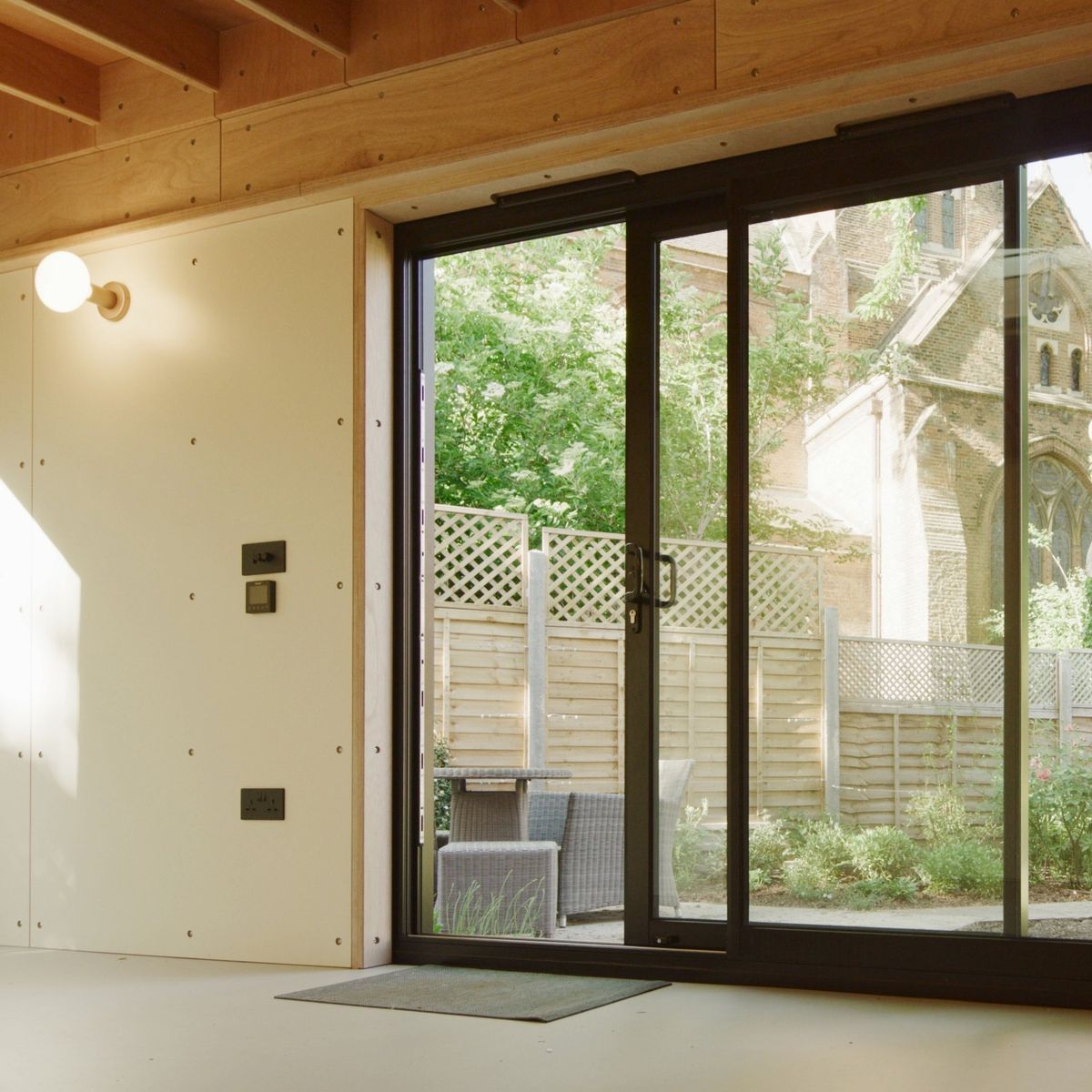 Sliding glass doors looking out to the garden and a Gothic church beyond