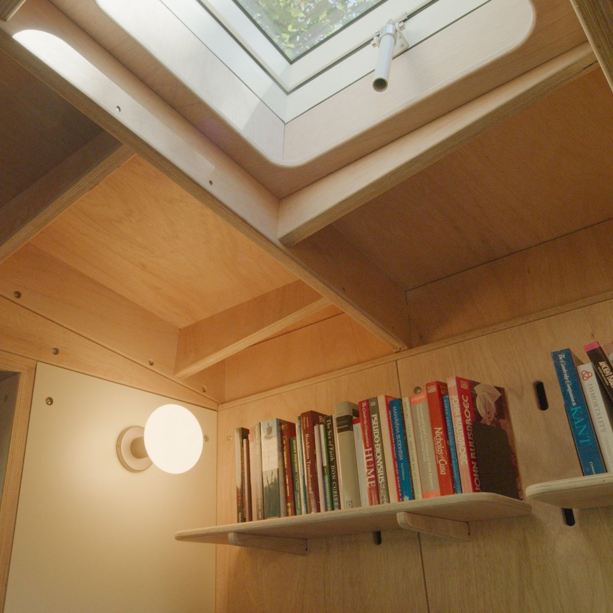 Wall light and bookshelf in the angled corner