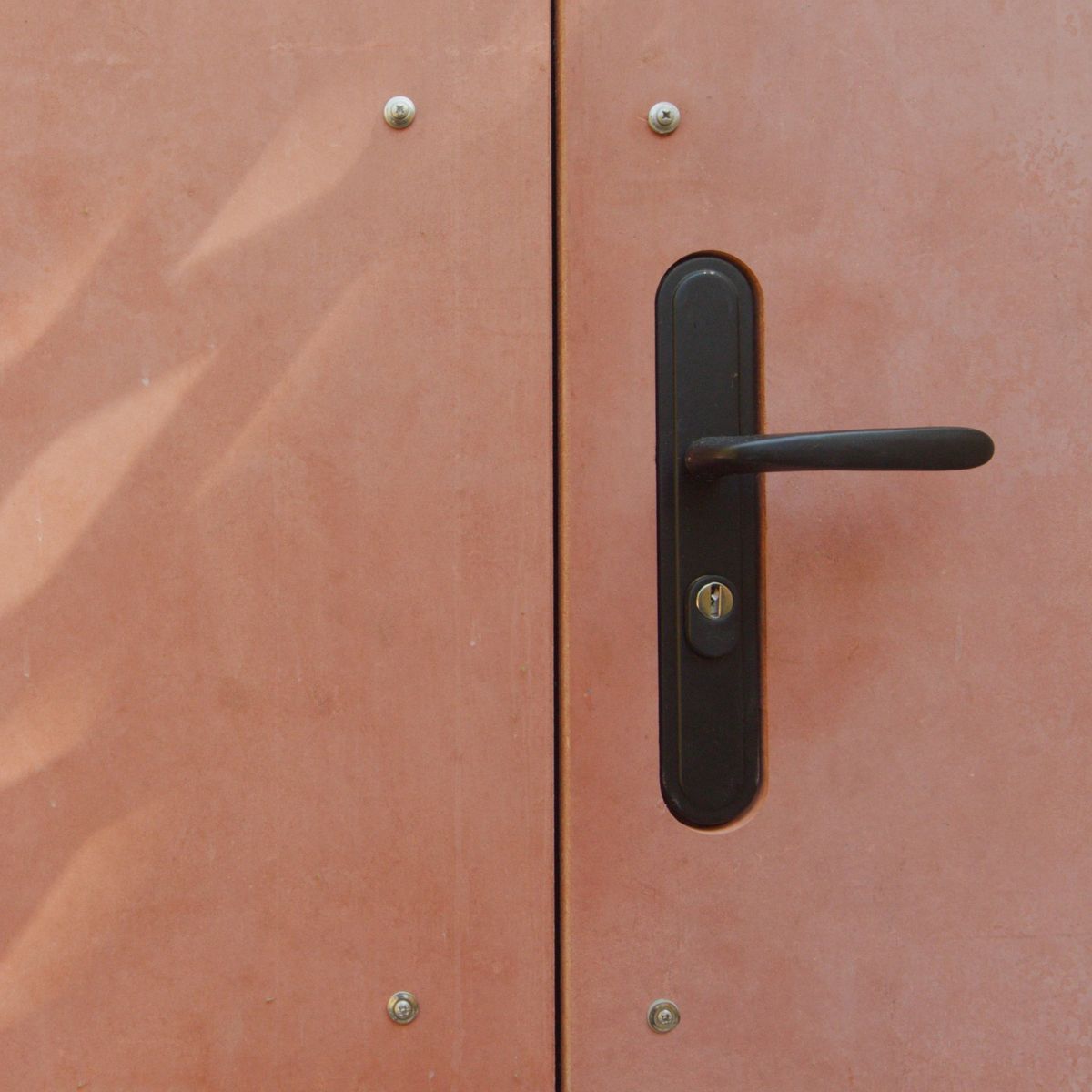 Door handle on the red Viroc cladding