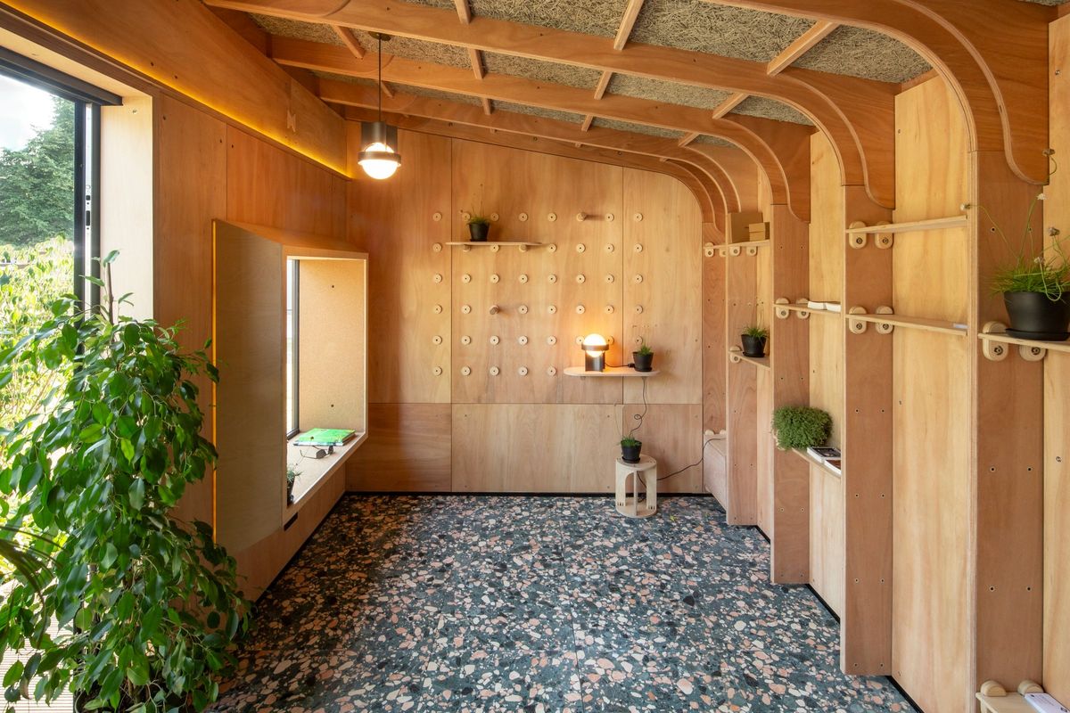 Inside the wellness studio: arched ply frames, window seat, peg wall and terrazzo floor