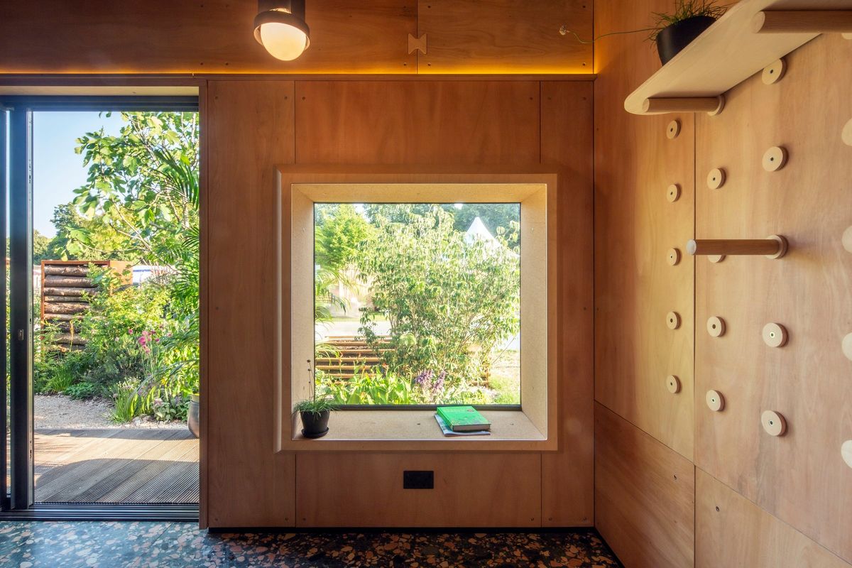 Picture window and door onto the garden, peg wall on the right