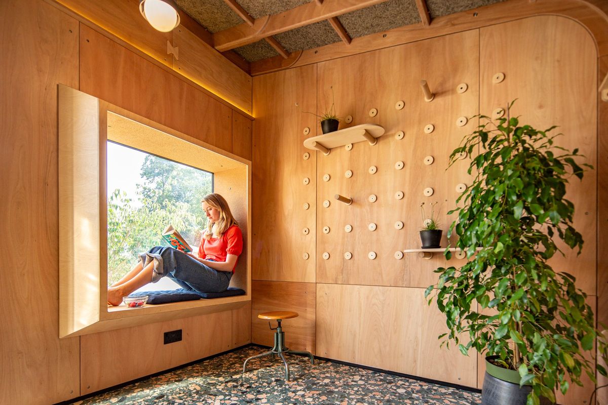 Wider view of the window seat, peg wall and shelves