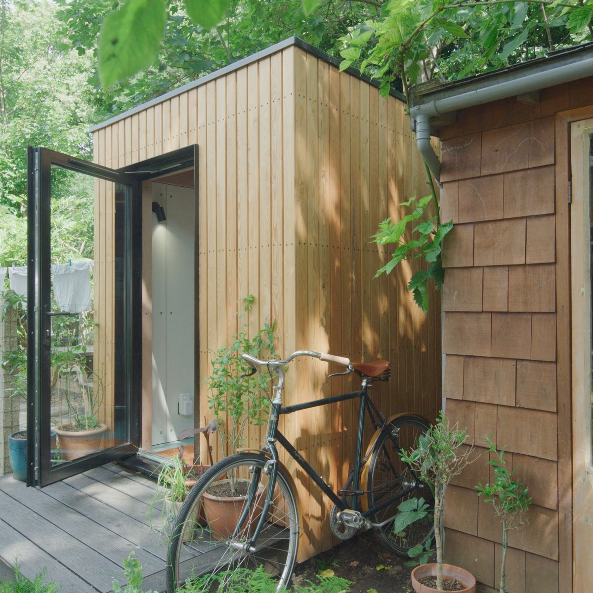 Side view with the door open and a bike against it