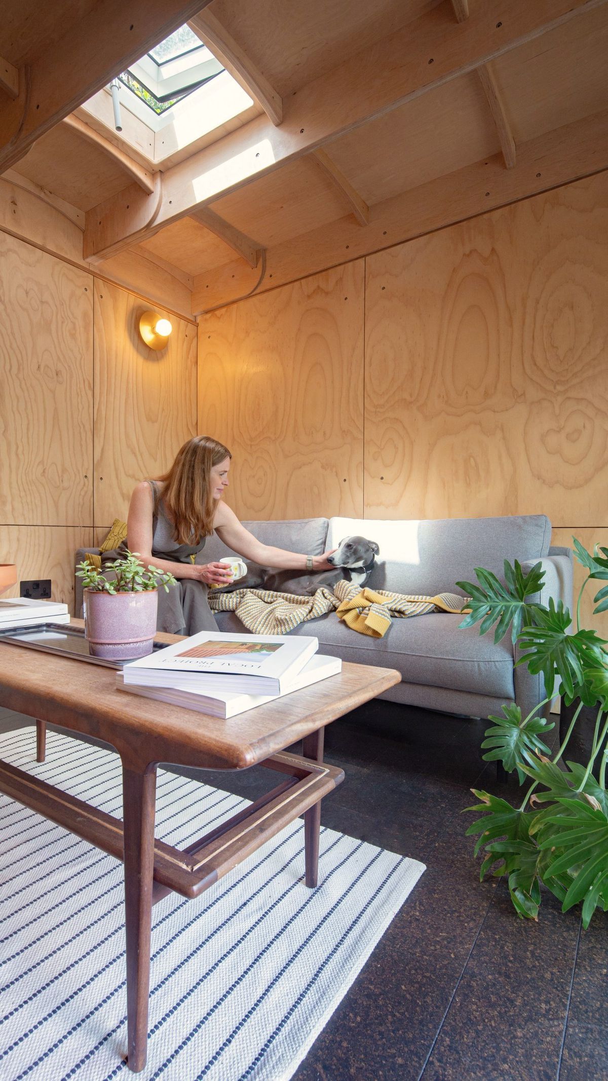 Woman relaxing on a sofa under the skylight in the studio’s lounge area