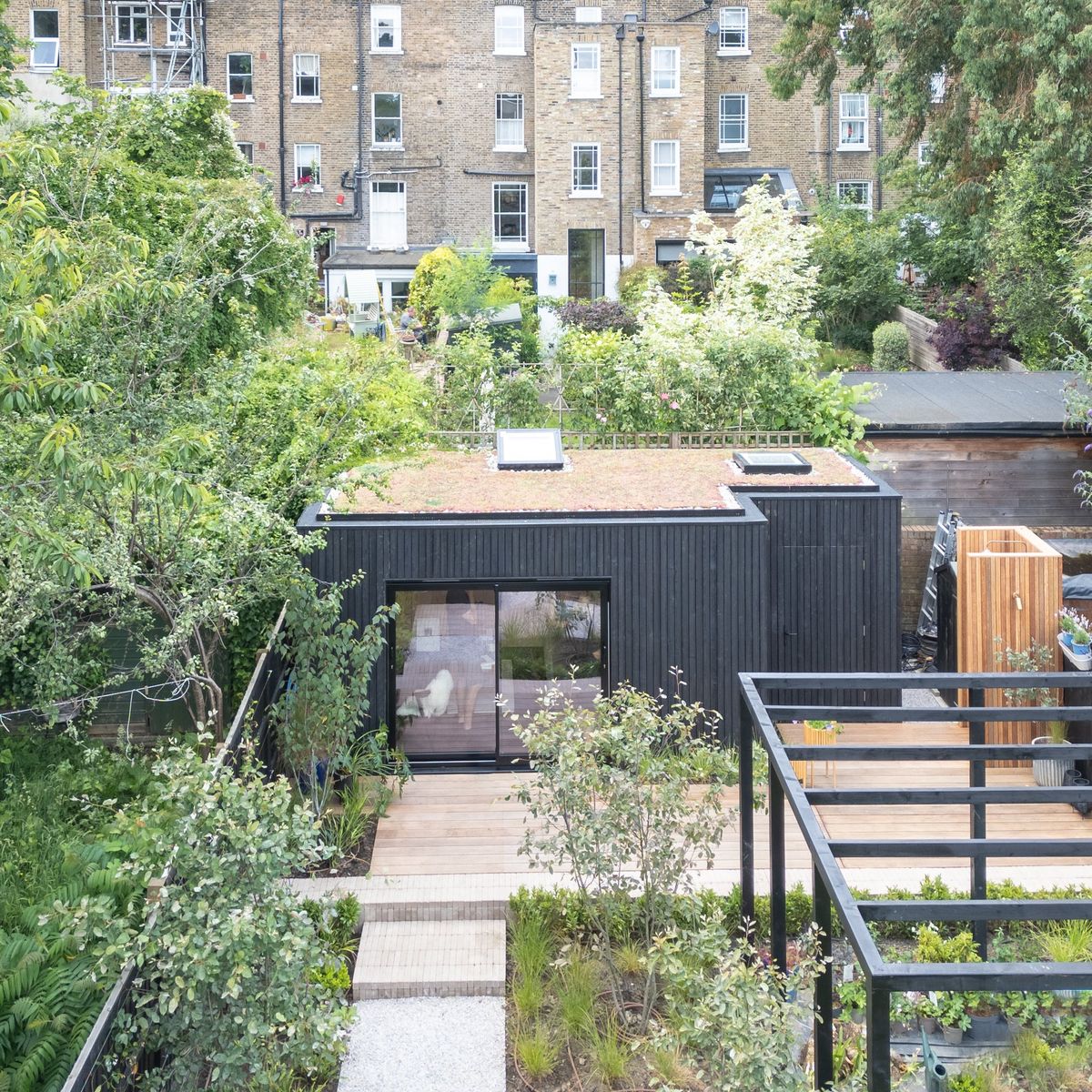 Aerial view of the studio with its green roof at the end of a terraced London garden