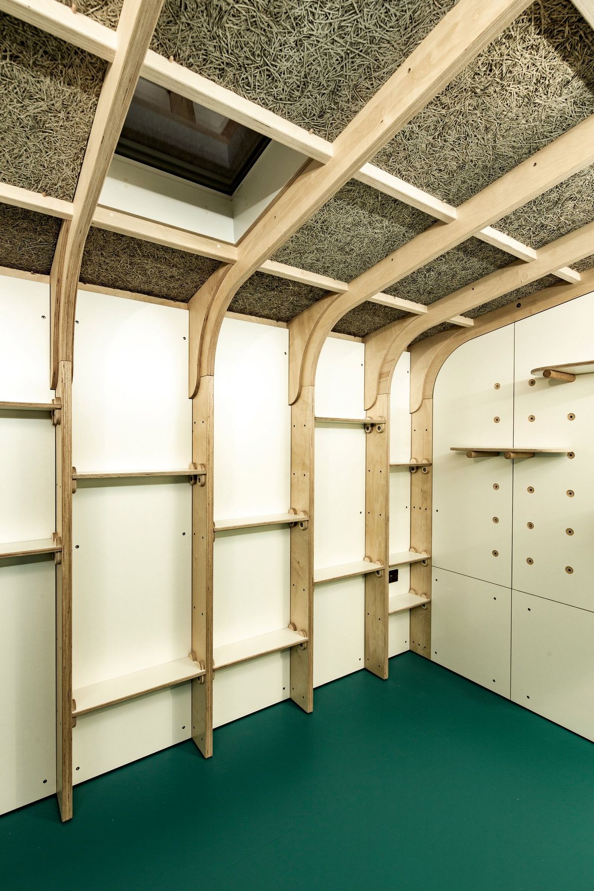 Shelving frames hung from the ceiling, skylight above
