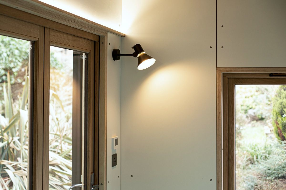 Oak doors, wall lamp and side window to the garden