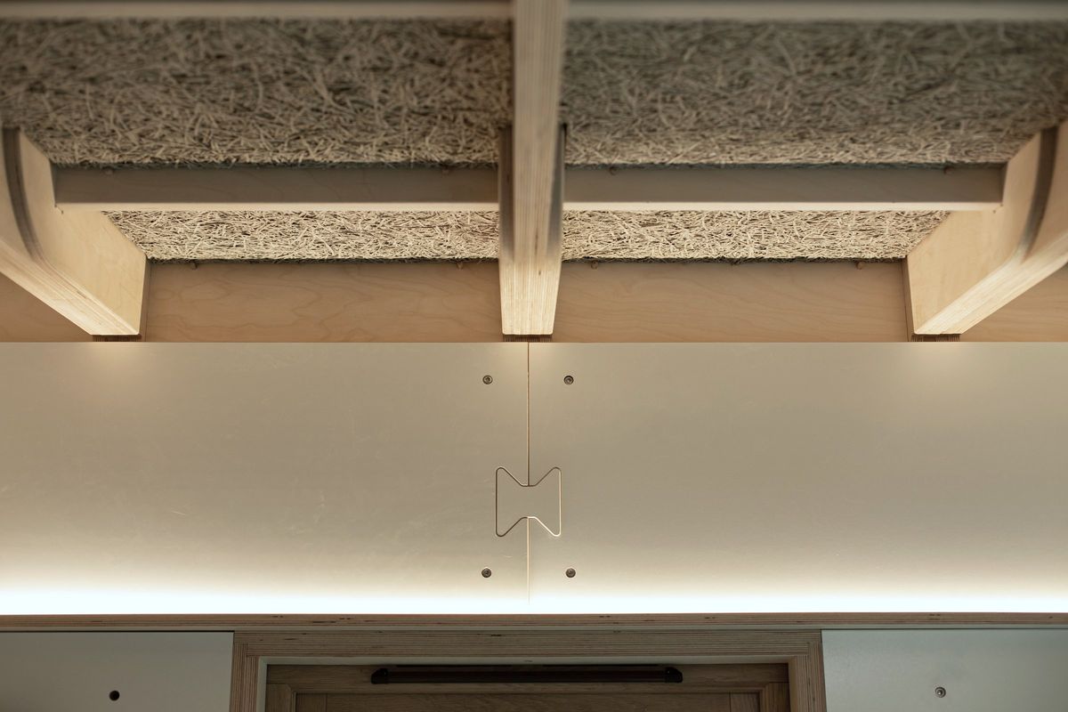 Wood-wool acoustic panels, joists and a bow-tie joint