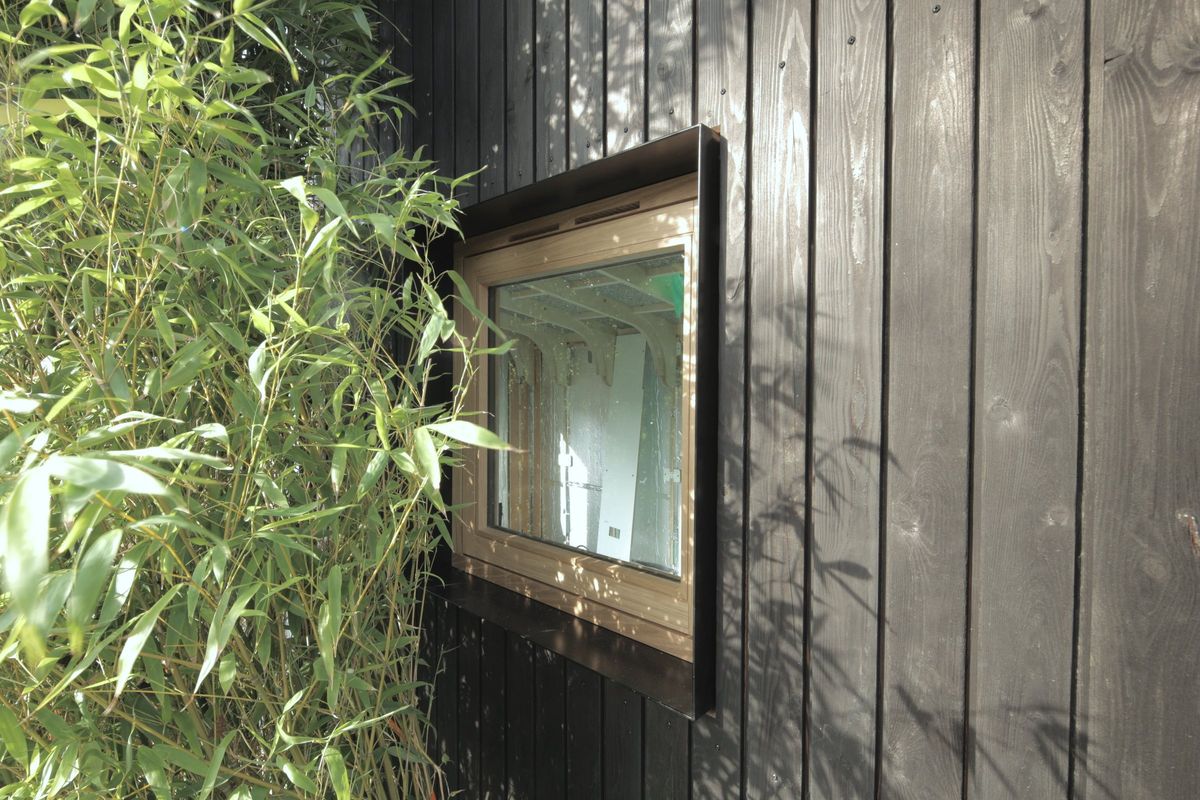 Small window in cladding, bamboo in front