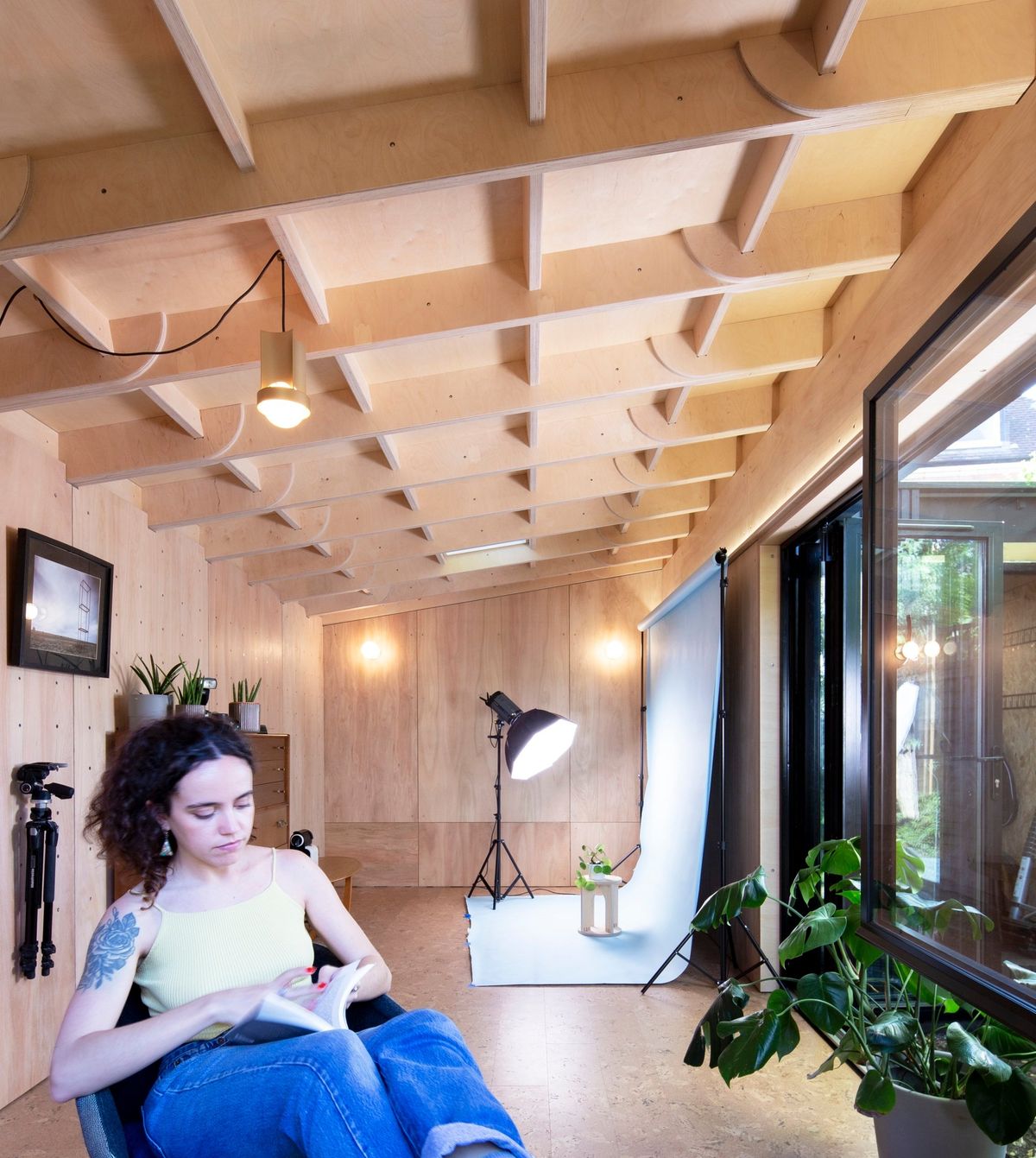 The long arm of the L: exposed roof joists, cork floor and the photo set at the far end
