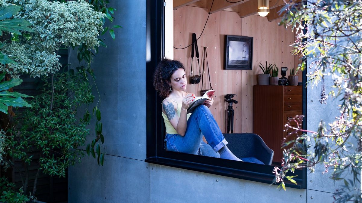 Reading in the window seat, seen from the garden