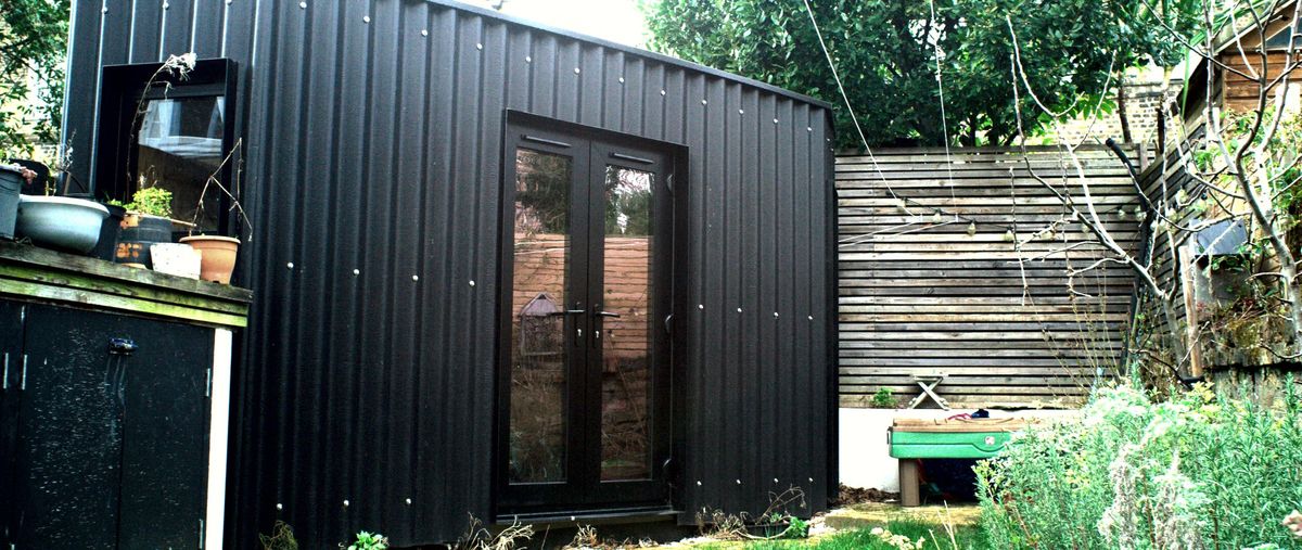 Front of the black corner studio with its glazed door