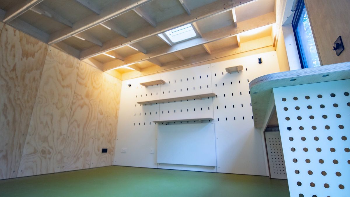 Peg wall, shelves, skylight and the perforated desk end