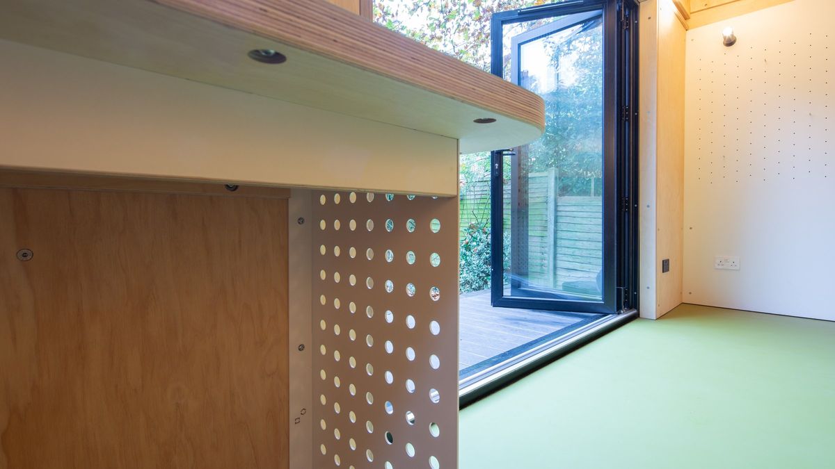 Perforated desk side panel against the open doors